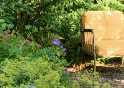 Family garden in Godalming with gravel seating area, pond and dog-friendly layout.