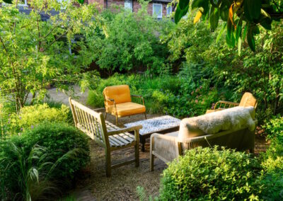Relaxing small garden design in Godalming with seating for family and pet dog.